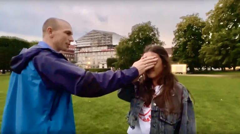Peter Skov praying for healing the eyes of a young woman.