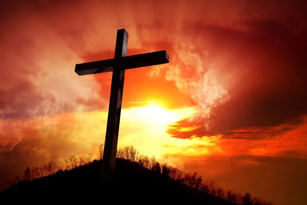 cross on a hill at sunset