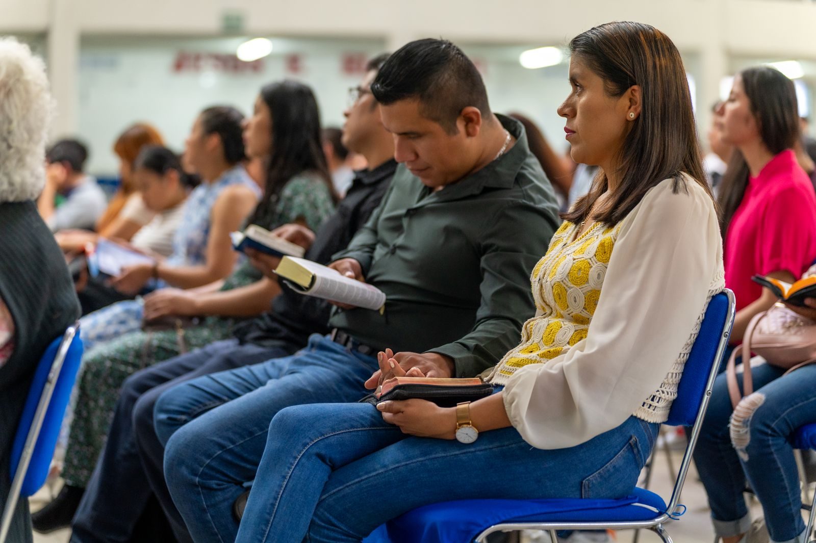 People reading the Bible together at a Christian gathering