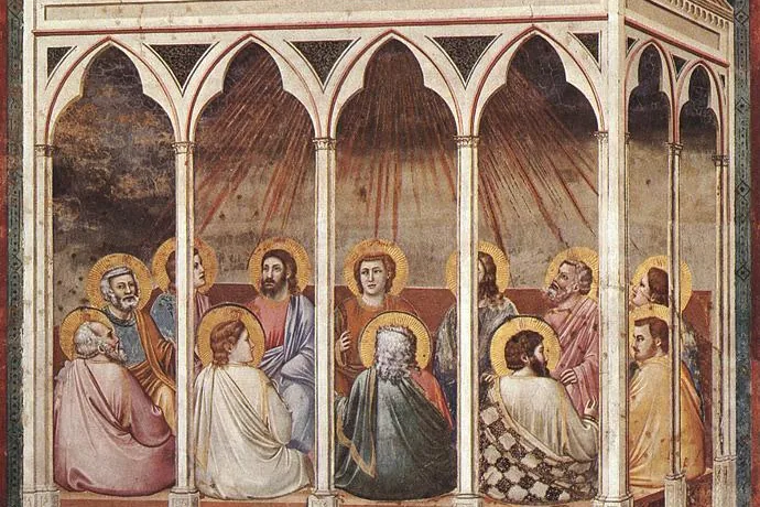 Fresco of the apostles seated together in a hall as rays of the Holy Spirit descend on them at Pentecost