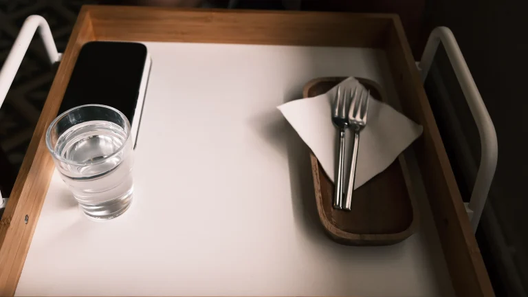 A simple tray with only a glass of water and cutlery, a picture of fasting
