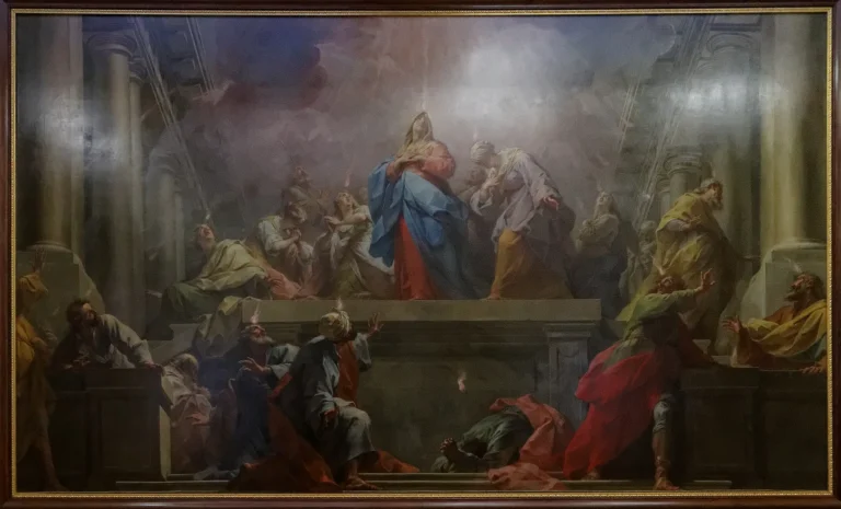 Painting of Mary and the apostles in a columned hall, with small flames above their heads as the Holy Spirit descends at Pentecost