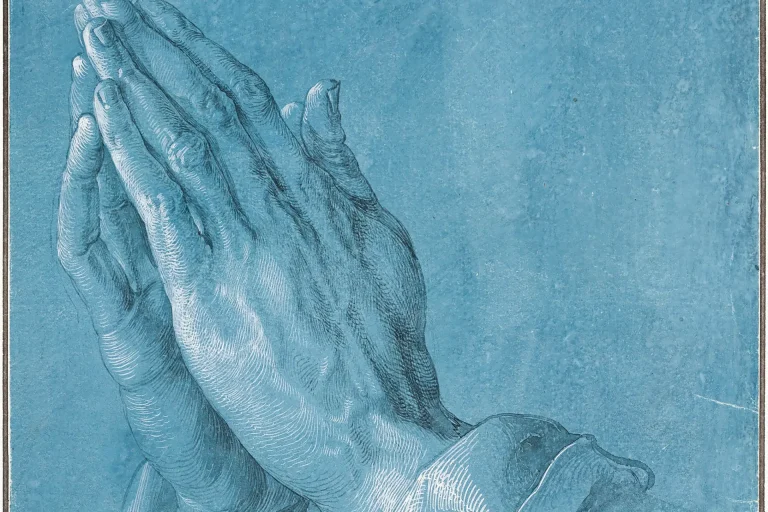 Drawing of two hands pressed together in prayer on blue paper